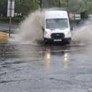 DPD Parcel delivery van wades through water on the Queslett Road roundabout