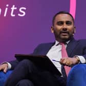 Amol Rajan speaking while seated in an armchair on a stage
