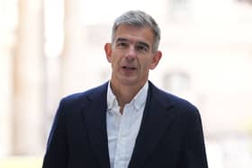 Matt Brittin standing outside, wearing a suit