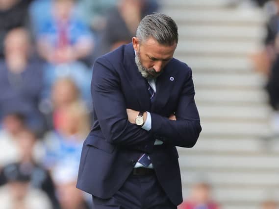 Rangers manager Derek McInnes looks down towards the ground