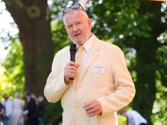 Hugh Bonneville speaking into a microphone at the Gold Award celebrations at Buckingham Palace