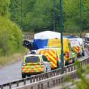 Police officers at the scene of the crash on the A66