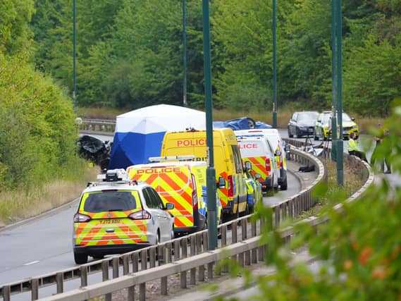 Police officers at the scene of the crash on the A66