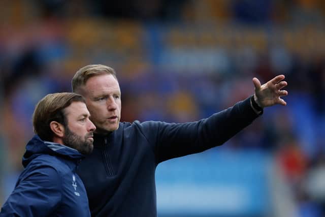 Shrewsbury Town boss Gavin Cowan in conversation with assistant Jamie Haynes 