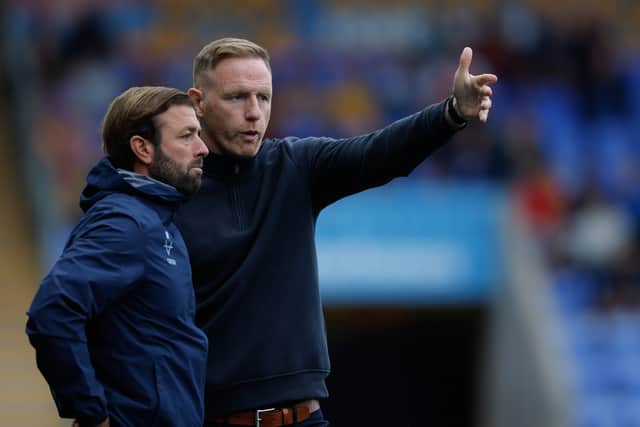 Shrewsbury Town manager Gavin Cowan (right) in discussion with assistant Jamie Haynes 