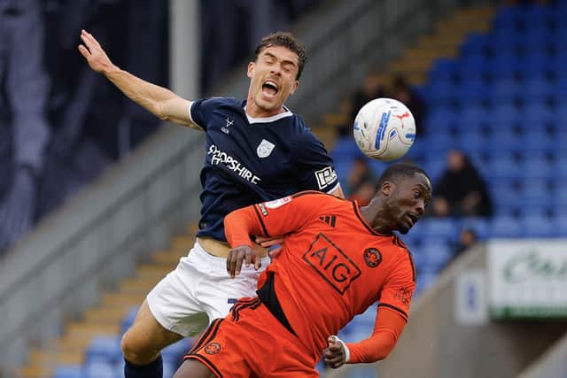 Josh Ruffels battles with Shrewsbury Town favourite and Salford City striker Daniel Udoh 