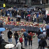 Flowers and cards are laid at the Blue Stone in Bergen
