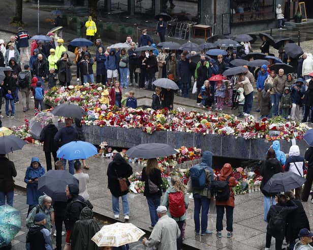 Flowers and cards are laid at the Blue Stone in Bergen