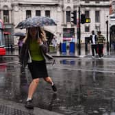 People walking in the rain near Victoria train station, London.