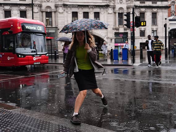 People walking in the rain near Victoria train station, London.