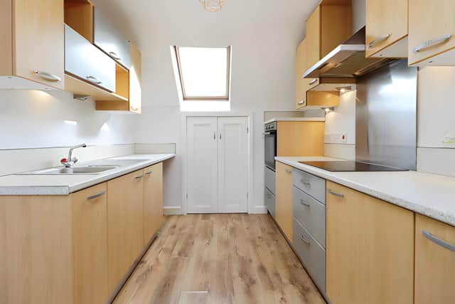 The kitchen forms part of the open-plan living space, combining everyday cooking with a sociable lounge area