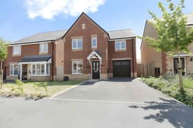 The Holland Drive frontage combines a modern detached design with a private driveway and integral garage