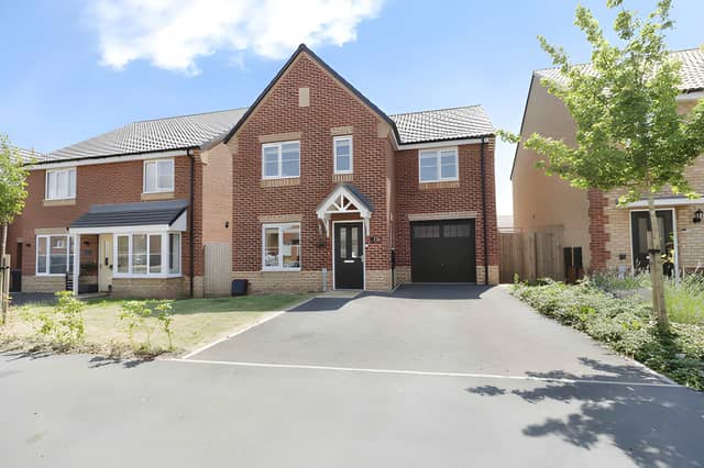 The Holland Drive frontage combines a modern detached design with a private driveway and integral garage