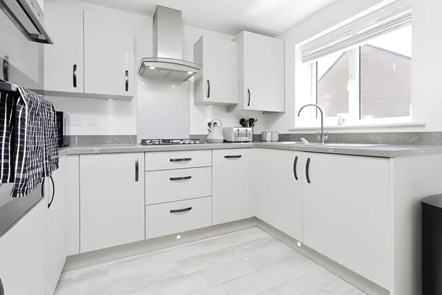 The contemporary fitted kitchen forms part of the open-plan dining and family area, with ample storage and high-quality appliances