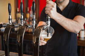 Barman pulling a pint stock image