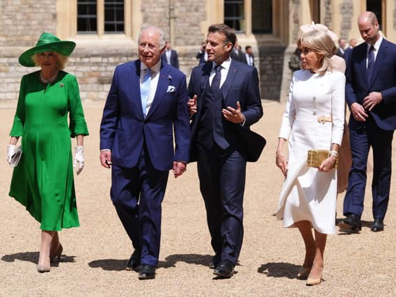 Queen Camilla, King Charles III, President of France Emmanuel Macron and his wife Brigitte Macron walk side by side at the Ceremonial Welcome for his state visit to the UK, at Windsor Castle in 2025