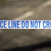 Police tape near the scene of a suspected crime