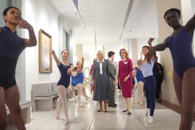 Dancers greet the Queen during a visit to the Royal Academy of Danc