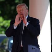 US President Donald Trump talks as he arrives at the Hotel Royal during the G7 summit in Evian, France
