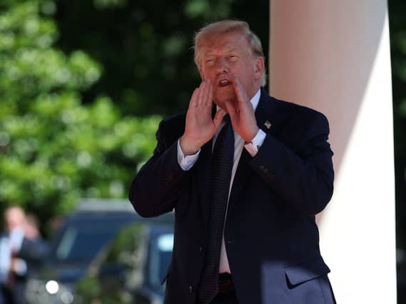 US President Donald Trump talks as he arrives at the Hotel Royal during the G7 summit in Evian, France