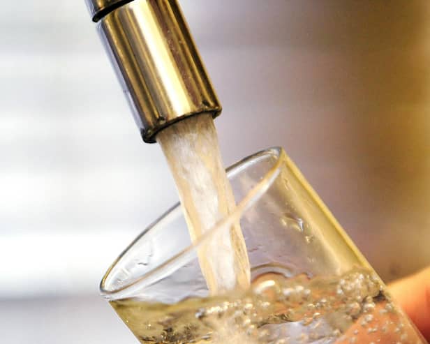 Water pouring into a tap