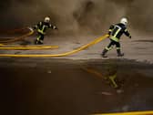 Firefighters try to extinguish a fire at a destroyed warehouse after Russian drone attacks on the outskirts of Kyiv