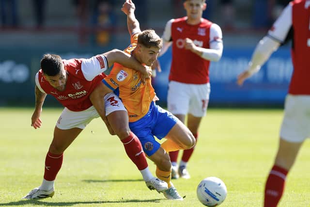 George Lloyd looks to get past Fleetwood Town’s Danny Andrew 