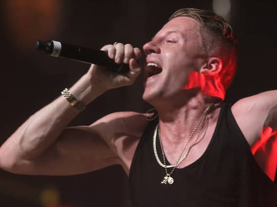 Macklemore performing on stage