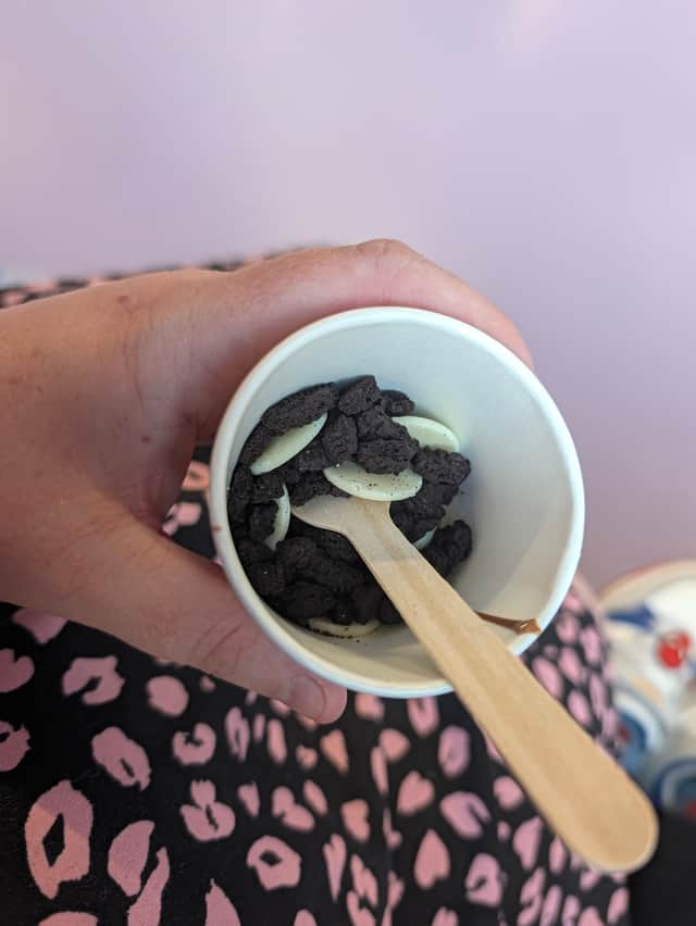 Oreo crumbs and white chocolate buttons on a sample of melted Cadburys chocolate