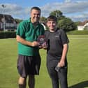Proud as punch Pritchard- League Handicap winner Jamie Pritchard gets his reward from Rob Burroughs