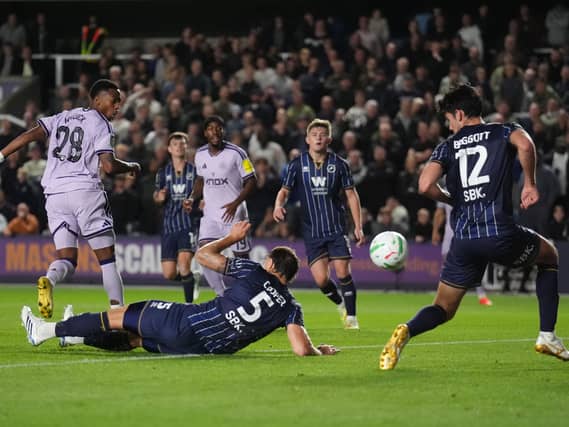 Joe Willock, left, scores