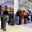 Air passengers waiting in a queue in an airport