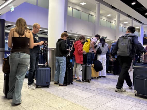Air passengers waiting in a queue in an airport
