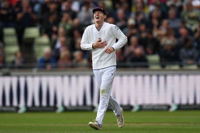 Theo Wylie gets the giggles after taking a catch as a substitute fielder to dismiss Shan Masood
