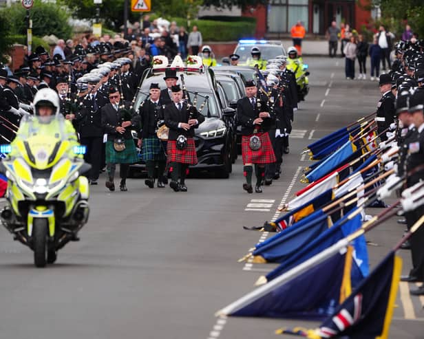 Bagpipers lead the funeral cortege through the streets lined with police colleagues at the ceremonial parade to the funeral of Pc Matthew Blades