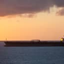 An oil tanker at sea at sunset