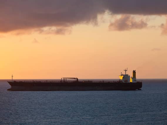 An oil tanker at sea at sunset
