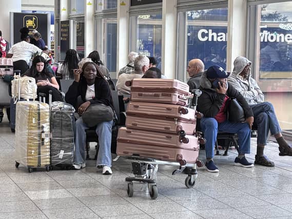 Passengers wait at Gatwick Airport during disruption after a system issue hit Nats
