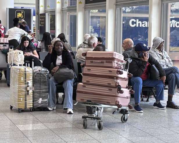 Passengers wait at Gatwick Airport during disruption after a system issue hit Nats