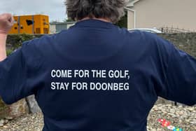A man wears a t-shirt promoting Doonbeg