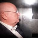 Side view of Peter Murrell in the back of a prison van
