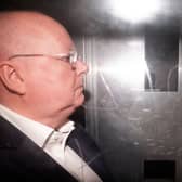Side view of Peter Murrell in the back of a prison van