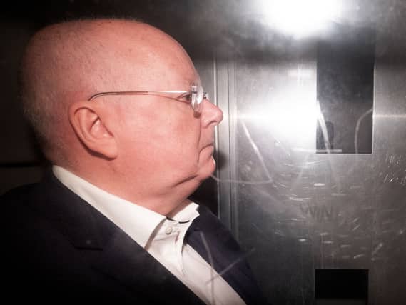 Side view of Peter Murrell in the back of a prison van