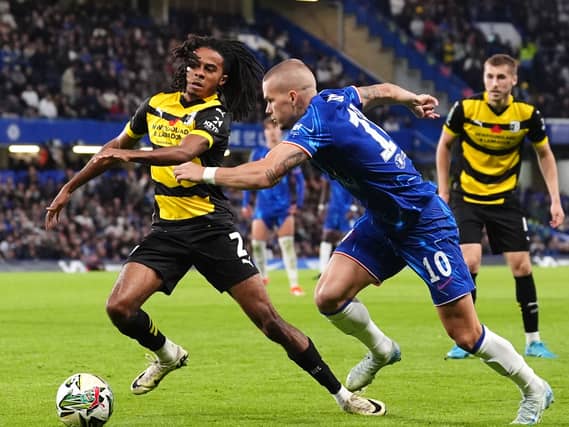 Neo Eccleston, left, in action for Barrow against Chelsea