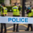 Police are working to identify a man found dead in Powys