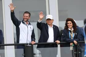 US President Donald Trump with his son Eric Trump waving to spectators