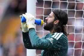 Liverpool goalkeeper Alisson Becker takes a drink during a match