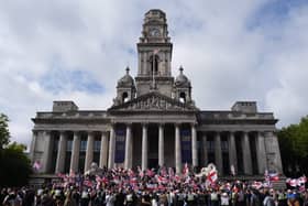 View of a group of protesters, with many waving UK and English flags