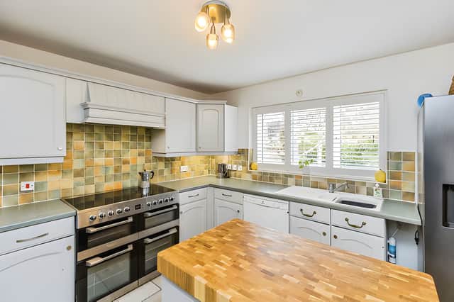 The practical kitchen and adjoining dining area form part of a ground-floor layout designed around modern family living
