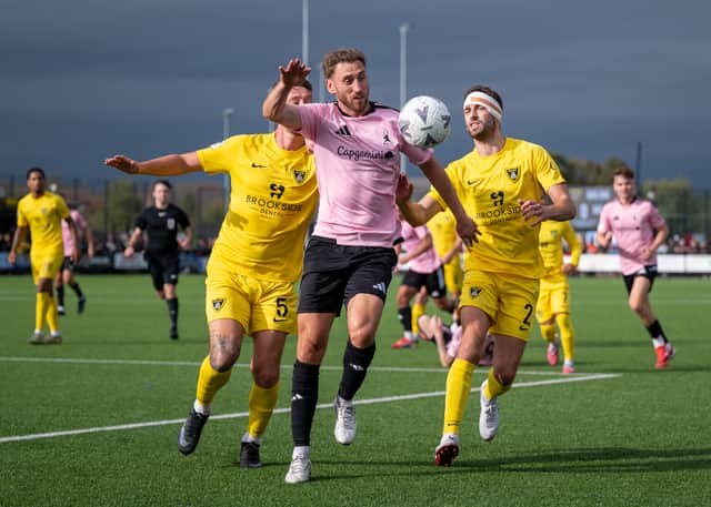 Louis Moult battles for the ball